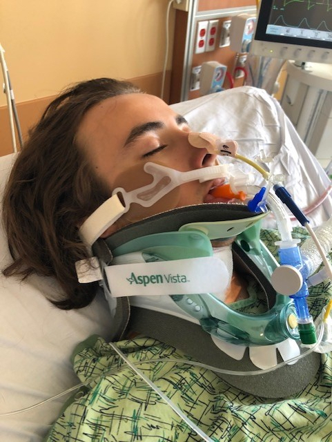 Young male patient in hospital bed